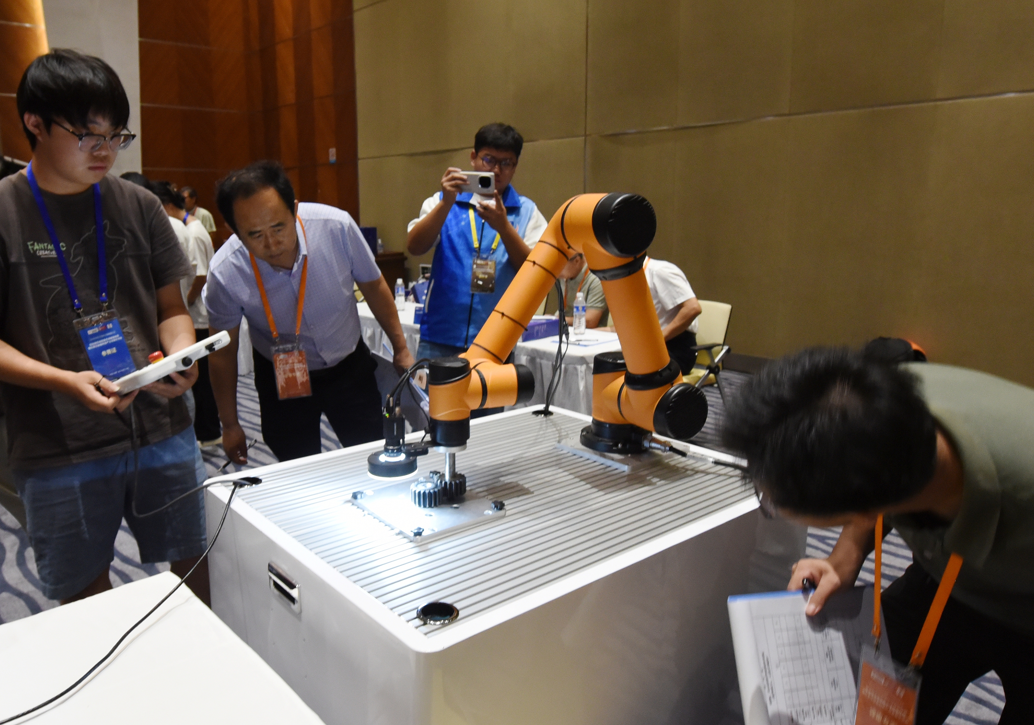 2025年中國大學生機械工程創新創意大賽智能精密裝配賽京津冀魯聯賽現場，評委對參賽選手進行實操調試評比。